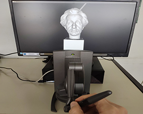 geomagic touch X haptic device used on computer